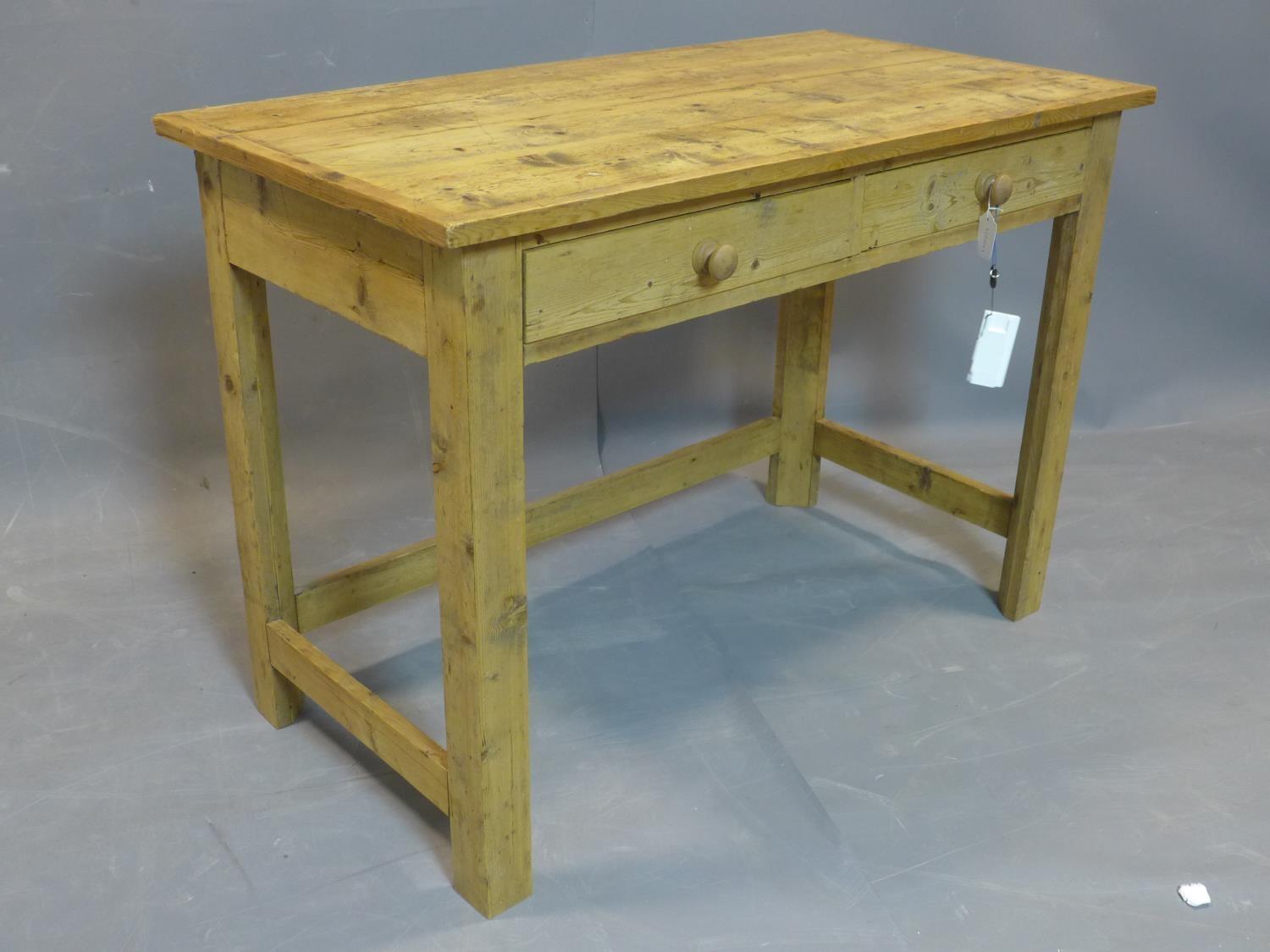A 20th century pine table, with two drawers, raised on square legs joined by stretcher, H.76 W.107 - Image 2 of 2