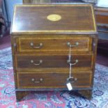 An Edwardian Sheraton Revival inlaid mahogany bureau, with shell paterae to slope, having fitted
