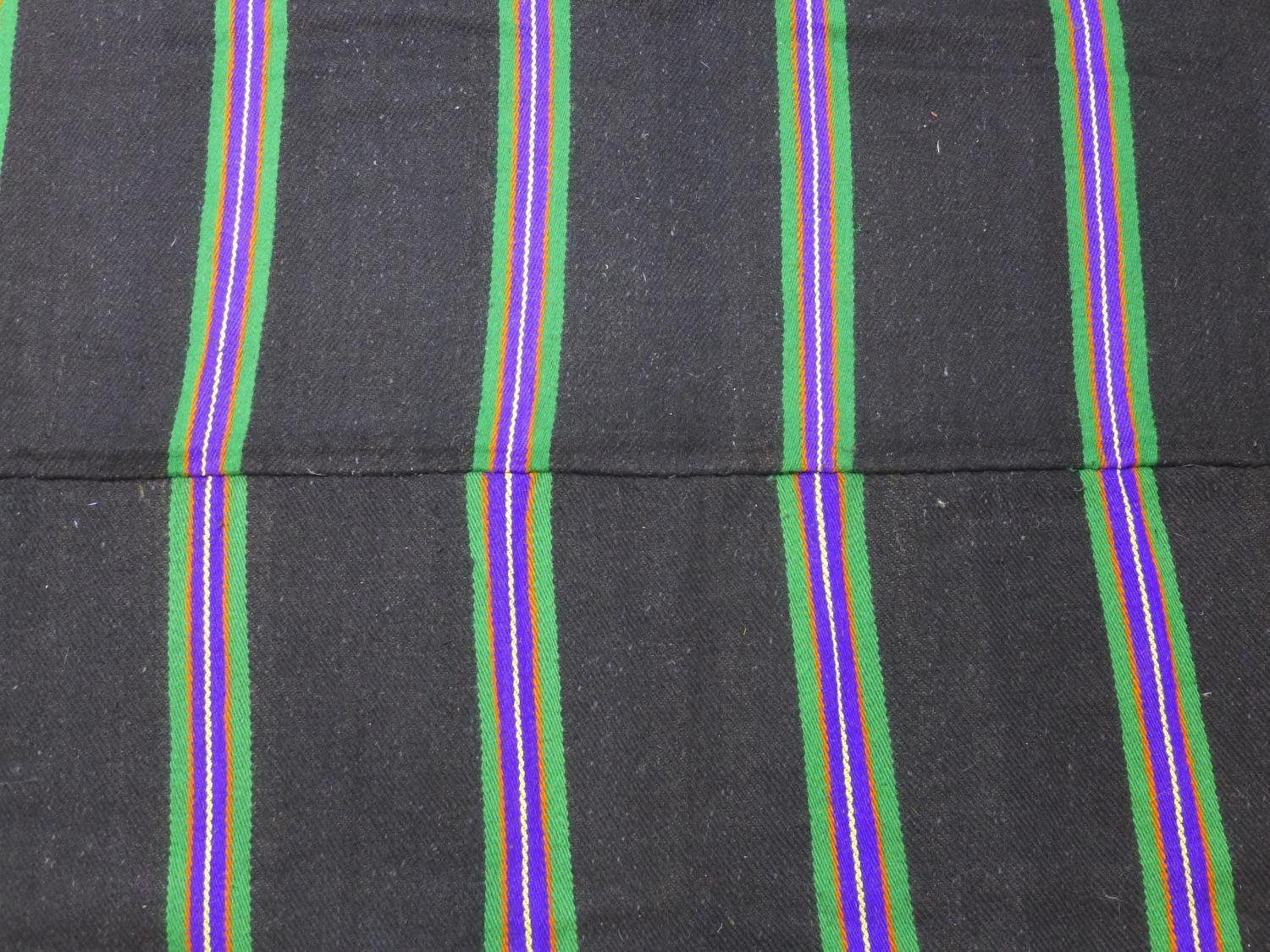 A woollen rug with purple, green, yellow and orange stripes on a black ground, 223 x 143 - Image 3 of 4