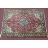 A central persian Qum Rug 200cmx140, central double pendant medalion, with repeat floral motifs, and