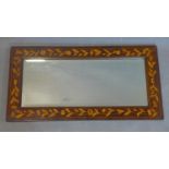 A late 19th or early 20th century Dutch marquetry inlaid mahogany wall mirror, inlaid with