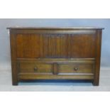 An early 20th century oak mule chest, with hinged lid above two short drawers, on square reeded