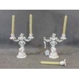 A pair of contemporary harms porcelain candelabras with putti