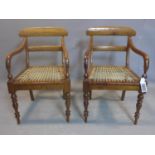 A pair of 19th century mahogany scroll armchairs, on turned baluster supports, having hide cord