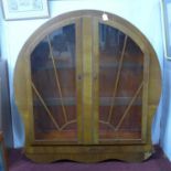 A 1940's Art Deco style walnut circular glass fronted display cabinet, the astragal glazed doors
