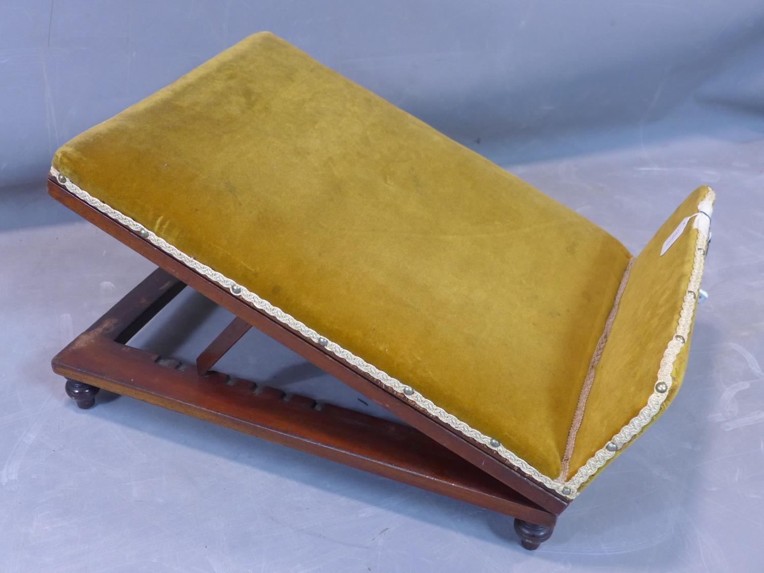 A 20th century gout stool, with stud bound velour upholstery, adjustable, H.29 W.47 D.63cm