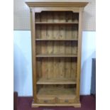 A 20th century pine bookcase, having two small drawers, on bracket feet, H.198 W.107 D.38cm