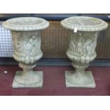 Two reconstituted stone Zoffoli style urns, decorated with continuous procession of Classical