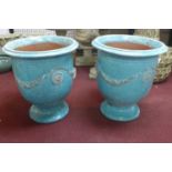 Two large Anduze urn style blue glazed planters, decorated with floral swags, on spreading feet, H.