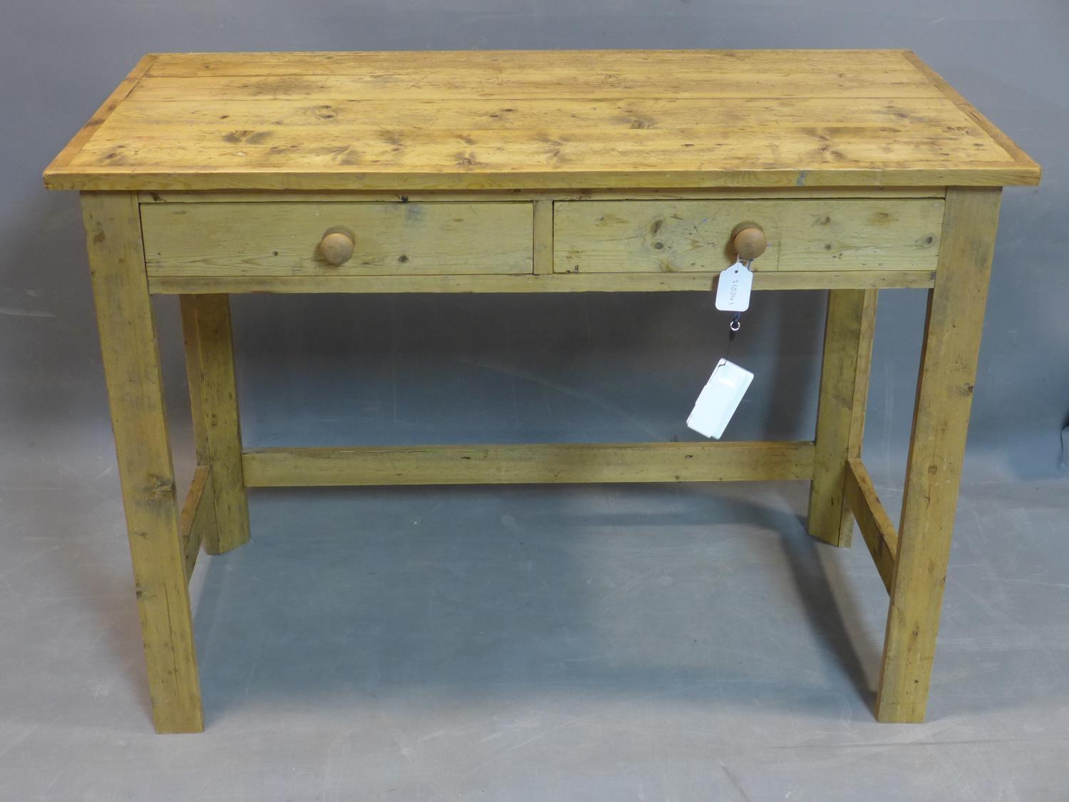 A 20th century pine table, with two drawers, raised on square legs joined by stretcher, H.76 W.107