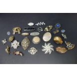 A collection of brooches to include gem set examples