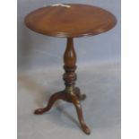 A 19th century mahogany wine table, with moulded round top above baluster turned support and
