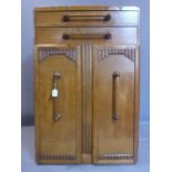 An Art Deco oak cabinet with two long drawers with horizontal handles above two cupboard doors