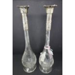 A pair of late Victorian cut glass candle holders with silver collars