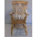 A large mid 19th century elm Windsor carver chair, on turned legs joined by stretcher