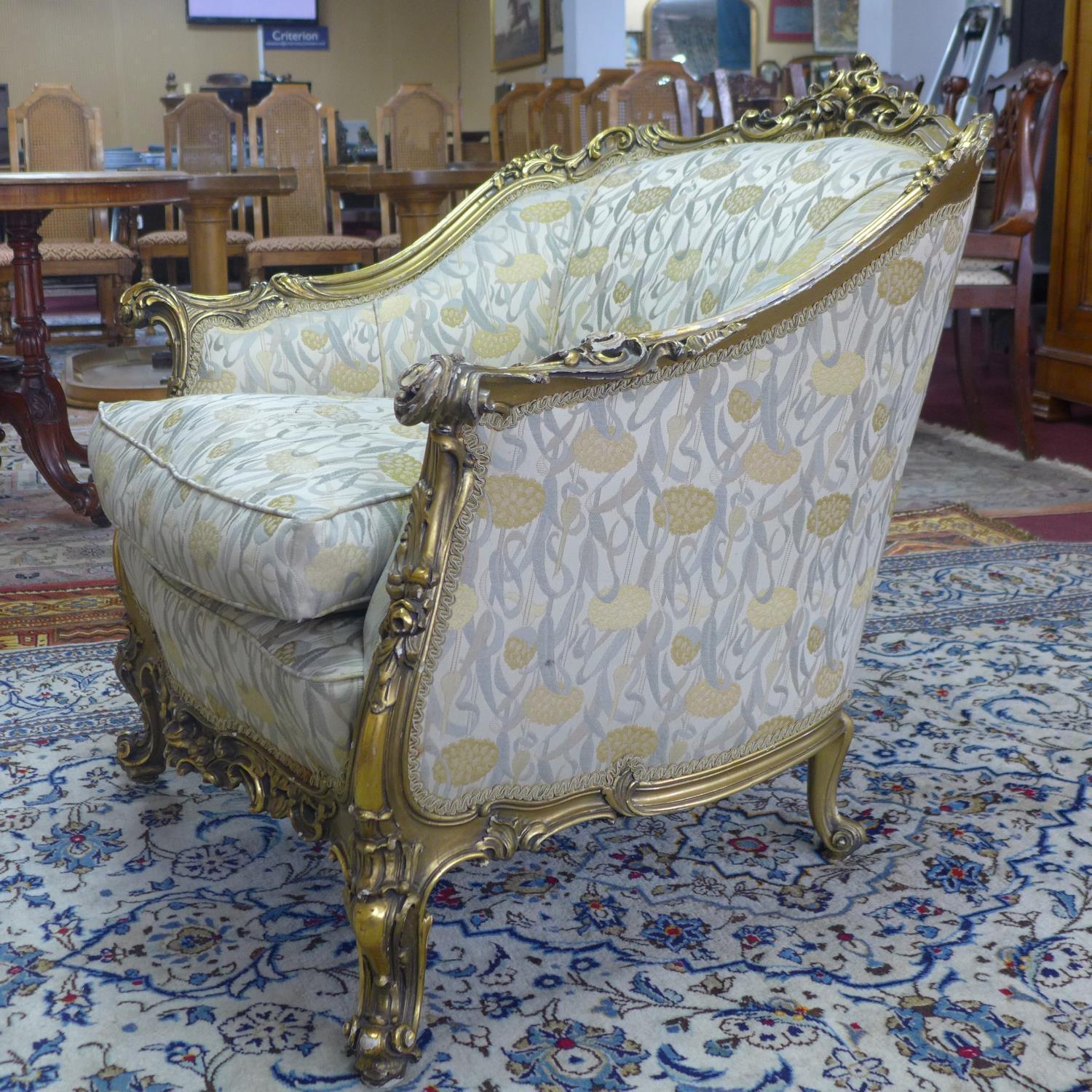 A pair of giltwood armchairs, with elaborate c-scroll and floral carved giltwood frames, on c-scroll - Image 6 of 7
