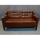 A brown leather 2 seater sofa, with button back cushions, on tapered legs, H.80 W.153 D.73cm, wear