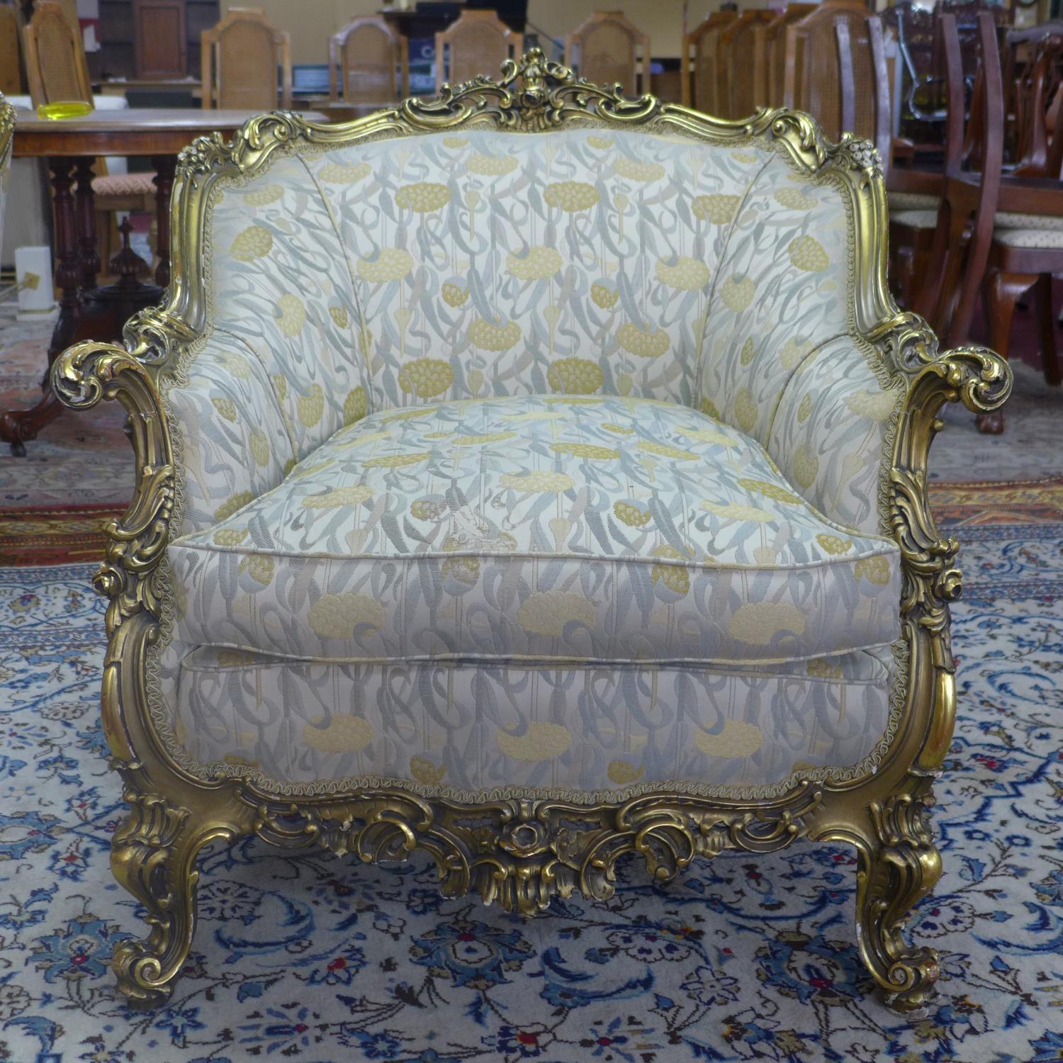 A pair of giltwood armchairs, with elaborate c-scroll and floral carved giltwood frames, on c-scroll - Image 2 of 7