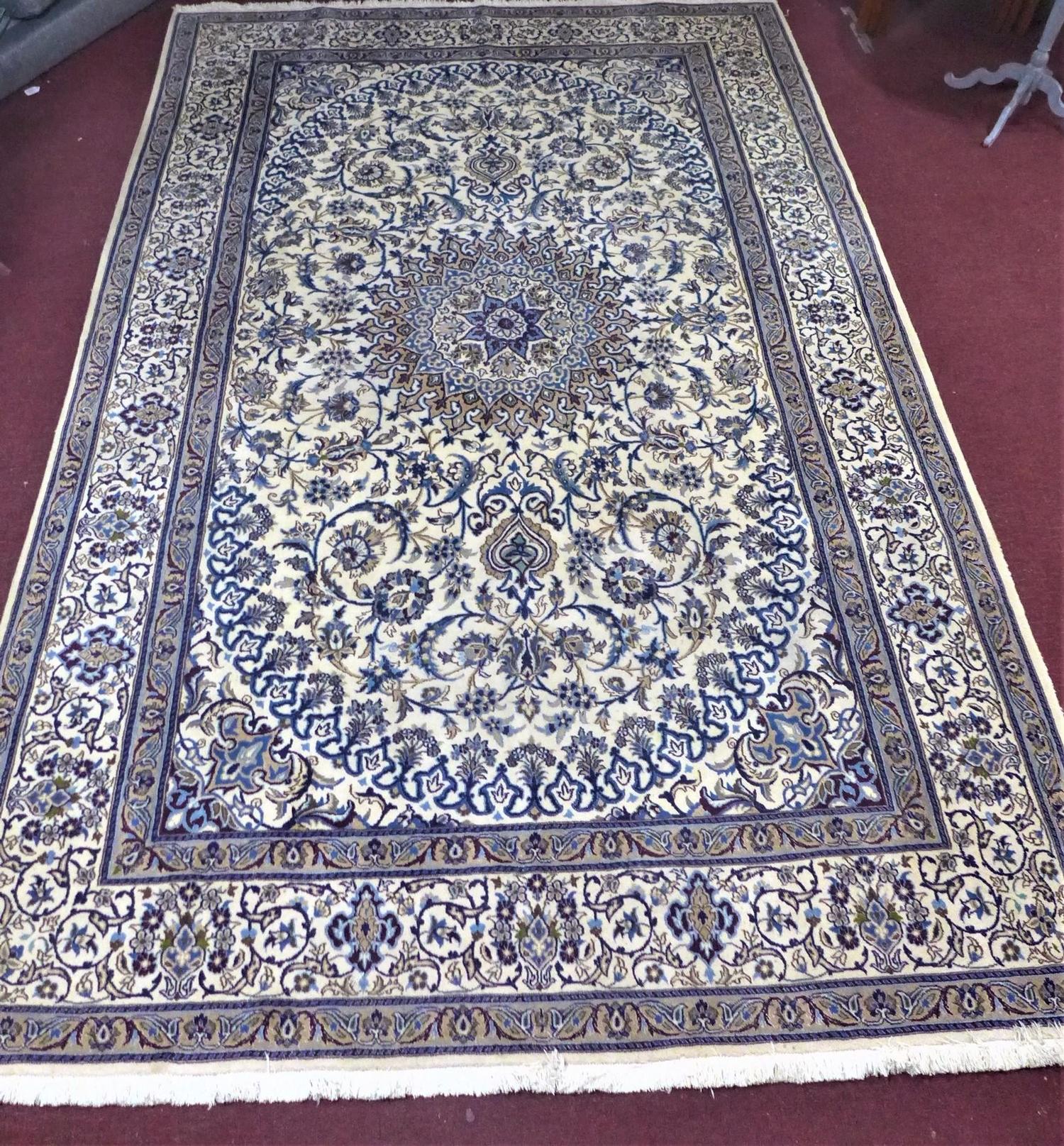 A large part silk Persian Nain Isfahan carpet, central medallion and stylised floral motifs on a