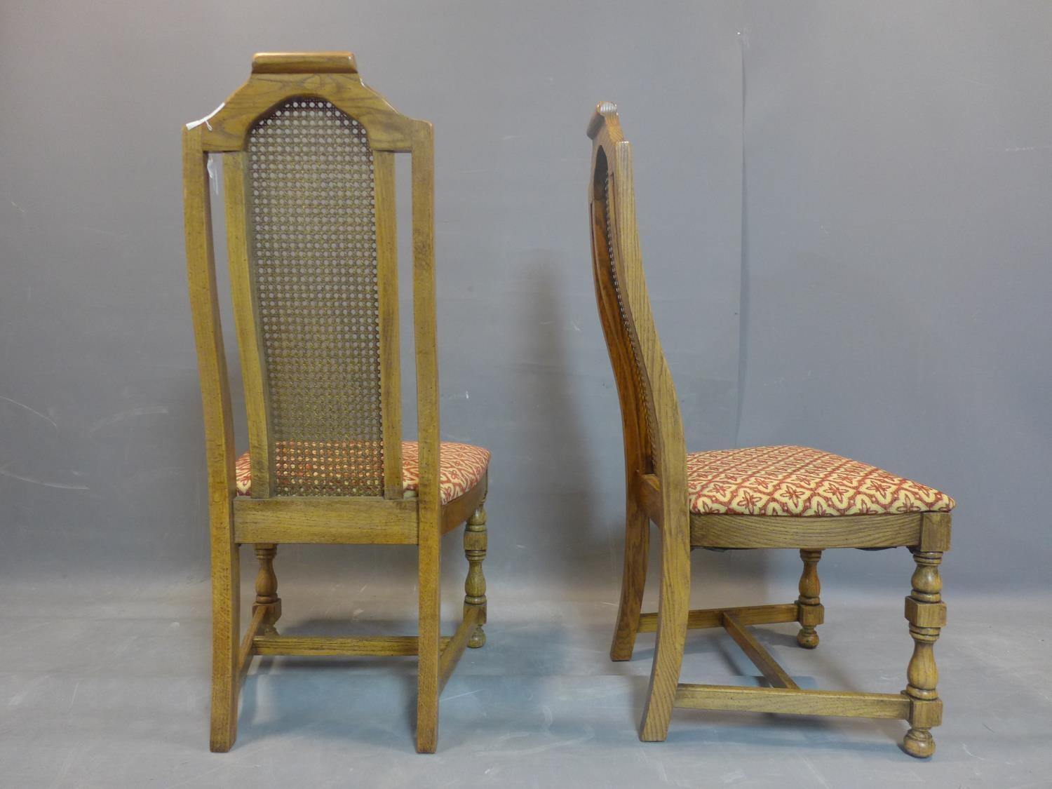 A set of eight fruitwood dining chairs with caned rattan back rests, having floral upholstered - Image 3 of 3