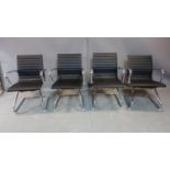 A set of four Eames style chairs in black upholstery and chrome bases