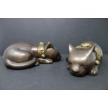Two bronze sleeping cats