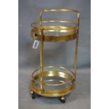 An Art Deco style gilt metal glass topped drinks trolley