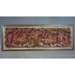 A Chinese red lacquer panel the design of ten sages in a garden 641 mm x 220 mm, probably 18th-