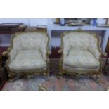 A pair of giltwood armchairs, with elaborate c-scroll and floral carved giltwood frames, on c-scroll