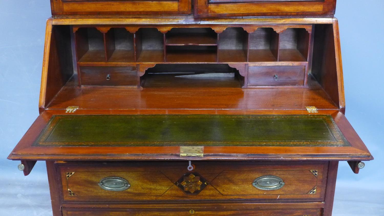 A 19th century inlaid mahogany bureau bookcase, the broken arch pediment above two astragal glazed - Image 3 of 5