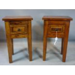 A pair of teak bedside tables