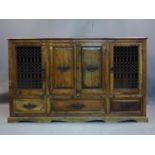 A large Indian hardwood sideboard, with two central doors flanked by two doors with scrolling