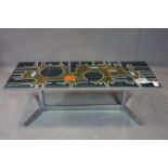 A 1970's tiled top coffee table on chrome base