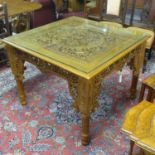 WITHDRAWN A middle eastern carved ornate table, some damage to the leg and the glass