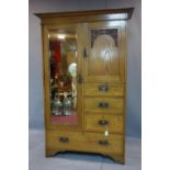 A early 20th century mahogany combination wardrobe comprising hanging space, cupboard and drawers