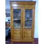 A large 19th century French fruitwood bibliotheque display cabinet, with a pair of glazed and
