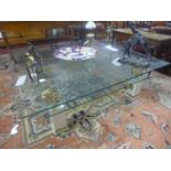 A two tier glass coffee table, with painted wooden supports with gilt brass lion stands, H.40 W.
