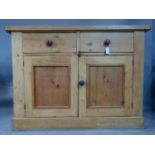 A pine two door sideboard, fitted drawers