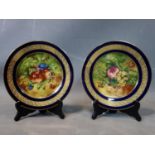 A pair of Limoges hand painted limited edition plates, signed A.J Heritage, edition number 103, D.