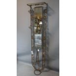 A 20th century metal hallstand with central rectangular ghosted glass plate and scrolling