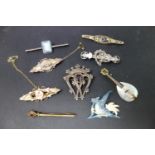 A collection of brooches, to include silver and gilt metal examples, one of scrolling floral form