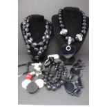 Five black plastic beads necklaces