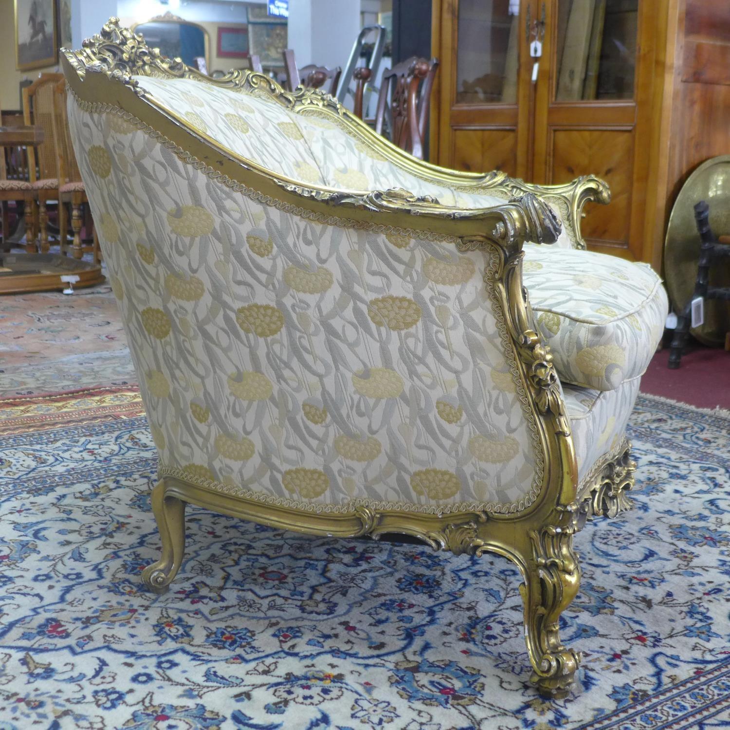 A pair of giltwood armchairs, with elaborate c-scroll and floral carved giltwood frames, on c-scroll - Image 3 of 7