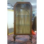 An early 20th century mahogany display cabinet, with astragal glazed door, on cabriole legs and claw