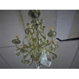 A contemporary six branched metal chandelier, hand painted wrought iron