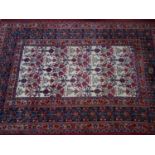A North West Persian Meshad carpet, signed, repeating urn and flower motifs on a cream ground,