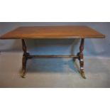 A mid 20th century mahogany occasional table, with cross-banded top raised on turned supports and