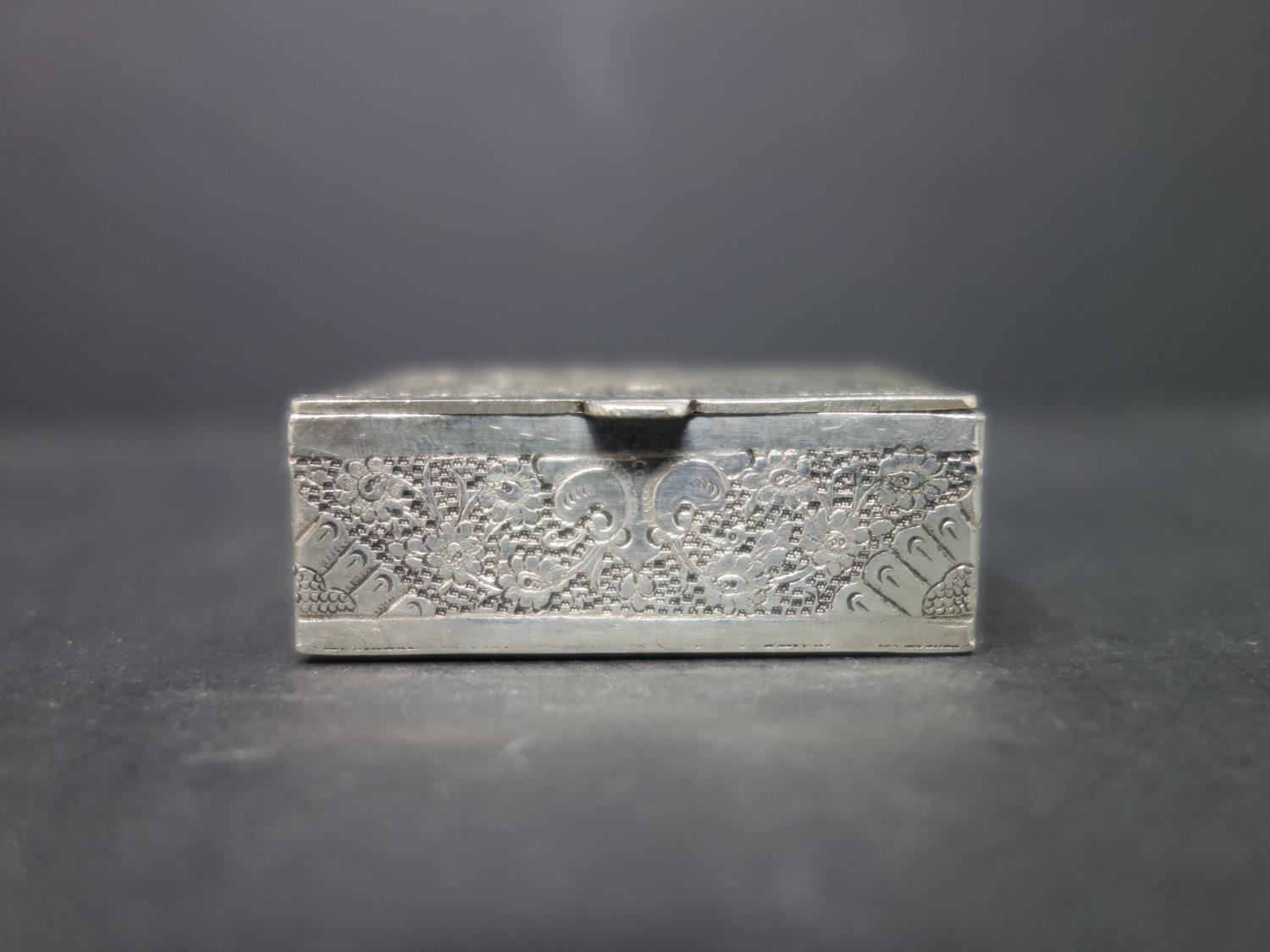 A Persian silver box, decorated with three figures and flowers, H.2 W.5.1 D.4cm, approx. 65g - Image 2 of 5