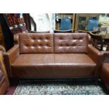 A brown leather 2 seater sofa, with button back cushions, on tapered legs, H.80 W.153 D.73cm