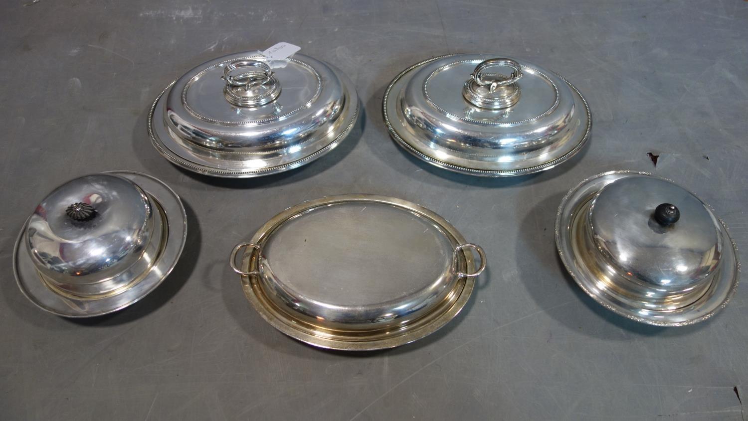 A collection of five silver plated tureens with covers